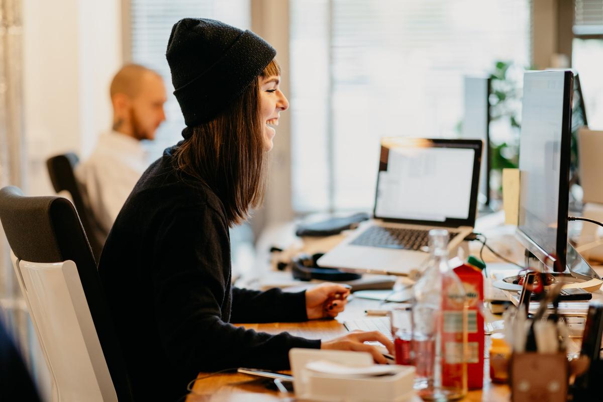 Laughing employee behind desk
